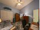 Inviting bedroom with a daybed, spacious closet, and a cozy, patterned rug at 39650 Us Hwy 19 N, Tarpon Springs, FL 34689