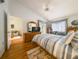 Bright bedroom with a comfortable bed, wood floors, and access to an outdoor seating area at 39650 Us Hwy 19 N, Tarpon Springs, FL 34689