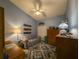 Comfortable bedroom featuring a vaulted ceiling, ceiling fan, and a cozy daybed at 39650 Us Hwy 19 N, Tarpon Springs, FL 34689