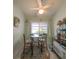 Charming breakfast nook featuring a bistro table set and storage and a microwave at 39650 Us Hwy 19 N, Tarpon Springs, FL 34689