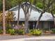 Community clubhouse featuring lush landscaping and available parking at 39650 Us Hwy 19 N, Tarpon Springs, FL 34689