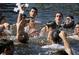 Gathering of people in the water in a traditional celebration, showcasing the area's cultural richness at 39650 Us Hwy 19 N, Tarpon Springs, FL 34689