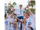 Community event showing men carrying another Personal on their shoulders while holding a trophy and crosses at 39650 Us Hwy 19 N, Tarpon Springs, FL 34689