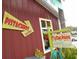 Quirky building with bright signs, unique signage, and plants at 39650 Us Hwy 19 N, Tarpon Springs, FL 34689