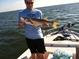 Angler proudly displays a freshly caught snook aboard a boat, highlighting fishing opportunities near the property at 39650 Us Hwy 19 N, Tarpon Springs, FL 34689