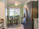 Cozy kitchen with a breakfast nook by the window and a stainless steel refrigerator at 39650 Us Hwy 19 N, Tarpon Springs, FL 34689