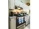 Well-equipped kitchen with stainless steel range and white cabinets, offering ample storage at 39650 Us Hwy 19 N, Tarpon Springs, FL 34689
