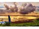 Scenic lake view with paddle boats and a colorful sunset reflecting on the water at 39650 Us Hwy 19 N, Tarpon Springs, FL 34689