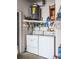 Functional laundry area with washer, dryer, and overhead shelving for storage at 39650 Us Hwy 19 N, Tarpon Springs, FL 34689
