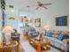 Cozy living room featuring a view of the dining area and laminate floors at 39650 Us Hwy 19 N, Tarpon Springs, FL 34689