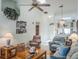 Cozy living room featuring laminate floors, a ceiling fan, and a view of the dining area at 39650 Us Hwy 19 N, Tarpon Springs, FL 34689