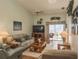 Bright living room with vaulted ceilings, ceiling fan, and sliding glass doors to patio at 39650 Us Hwy 19 N, Tarpon Springs, FL 34689