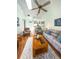 Comfortable living room with vaulted ceiling, ceiling fan, and wood laminate flooring at 39650 Us Hwy 19 N, Tarpon Springs, FL 34689