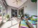 Screened lanai featuring comfortable seating and plants, perfect for relaxation and outdoor living at 39650 Us Hwy 19 N, Tarpon Springs, FL 34689