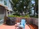 Outdoor patio featuring a grill, comfortable seating, and a privacy fence at 39650 Us Hwy 19 N, Tarpon Springs, FL 34689