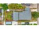 Aerial view of the property featuring a backyard deck, lush lawn, and a well-maintained roof at 400 E Jean St, Tampa, FL 33604