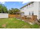 Spacious backyard featuring a wood deck with pergola, lawn and privacy fence, perfect for outdoor entertaining at 400 E Jean St, Tampa, FL 33604