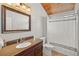 Bathroom features wood ceiling, granite countertop vanity, and tub with shower at 400 E Jean St, Tampa, FL 33604