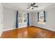 Bedroom featuring hardwood floors, two windows, and a ceiling fan at 400 E Jean St, Tampa, FL 33604