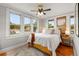 Sun-filled bedroom with three large windows, hardwood floors, ceiling fan and cozy decor at 400 E Jean St, Tampa, FL 33604