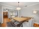 Formal dining room featuring wood floors, decorative light fixture, and a large wood table at 400 E Jean St, Tampa, FL 33604