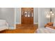 Open foyer boasting wood floors and a wood door with decorative glass accents at 400 E Jean St, Tampa, FL 33604