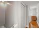 Bright hallway with hardwood floors, closet and natural light from windows, creating a warm and inviting atmosphere at 400 E Jean St, Tampa, FL 33604