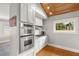 Bright kitchen with a wood ceiling, granite countertops, stainless appliances, and white cabinetry at 400 E Jean St, Tampa, FL 33604