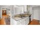 Bright kitchen featuring granite counters, stainless appliances, white cabinetry, and hardwood floors at 400 E Jean St, Tampa, FL 33604