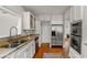 Bright kitchen with stainless steel appliances, white cabinets, and hardwood floors at 400 E Jean St, Tampa, FL 33604
