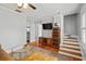 Cozy living room featuring hardwood floors, a ceiling fan, and a staircase to the upper level at 400 E Jean St, Tampa, FL 33604