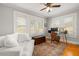 Office with hardwood floors, white trim, three windows with wooden blinds, and ceiling fan at 400 E Jean St, Tampa, FL 33604