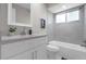 Modern bathroom features a large mirror, updated lighting, and neutral tile at 4418 Pine Meadow Ct, Tampa, FL 33624