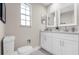 Bathroom featuring double sinks, quartz countertops, ample storage, and modern fixtures at 4418 Pine Meadow Ct, Tampa, FL 33624