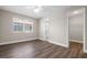 Neutral bedroom with wood-look floors, a ceiling fan, and a window bringing in natural light at 4418 Pine Meadow Ct, Tampa, FL 33624