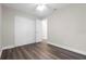 This empty bedroom features wood-look floors, a ceiling fan, and a sliding door closet at 4418 Pine Meadow Ct, Tampa, FL 33624