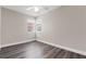 Empty bedroom with lots of natural light and wood-look floors in a neutral color at 4418 Pine Meadow Ct, Tampa, FL 33624