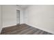 Neutral bedroom with wood-look floors and a closet is shown in this real estate listing photograph at 4418 Pine Meadow Ct, Tampa, FL 33624