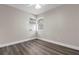 Neutral bedroom with wood-look floors and two windows is shown in this real estate listing photograph at 4418 Pine Meadow Ct, Tampa, FL 33624