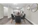 Dining area with modern decor next to a kitchen with white cabinets at 4418 Pine Meadow Ct, Tampa, FL 33624