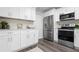 Renovated kitchen features stainless steel appliances, modern white cabinets, and beautiful quartz countertops at 4418 Pine Meadow Ct, Tampa, FL 33624