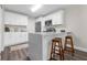 Bright kitchen with white cabinets, stainless appliances, and a quartz countertop island with bar seating at 4418 Pine Meadow Ct, Tampa, FL 33624