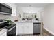 Open-concept kitchen with quartz countertops, stainless steel appliances, and a view into the living area at 4418 Pine Meadow Ct, Tampa, FL 33624