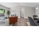 Bright and airy living area leading to a hallway, featuring neutral paint and luxury vinyl plank floors at 4418 Pine Meadow Ct, Tampa, FL 33624