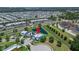 Aerial view of a blue home with a red pin highlighting location within the community at 449 Bahama Grande Blvd, Apollo Beach, FL 33572