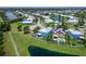 Desirable home with a pool, lush landscaping, and a charming white fence in a scenic waterfront setting at 449 Bahama Grande Blvd, Apollo Beach, FL 33572