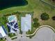 Aerial view of house with pool, solar panels, lush landscaping, and a circular driveway at 449 Bahama Grande Blvd, Apollo Beach, FL 33572