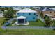Rear view of the home featuring a screened-in porch and a well-maintained, fenced-in yard at 449 Bahama Grande Blvd, Apollo Beach, FL 33572