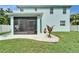 Backyard featuring a screened-in porch, a small garden area, and a well-maintained lawn at 449 Bahama Grande Blvd, Apollo Beach, FL 33572