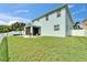 Spacious backyard featuring a screened-in porch, a small garden area, and a lush green lawn with a white fence at 449 Bahama Grande Blvd, Apollo Beach, FL 33572